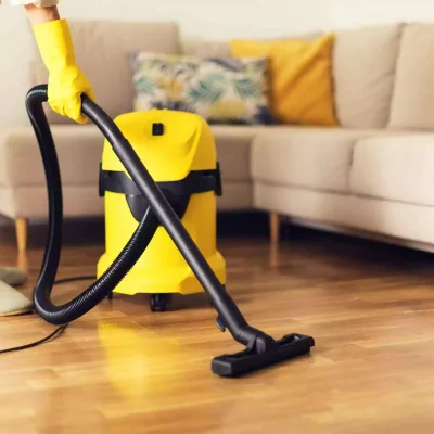 woman-cleaning-sofa-with-yellow-vacuum-cleaner-copy-space-cleaning-service-concept